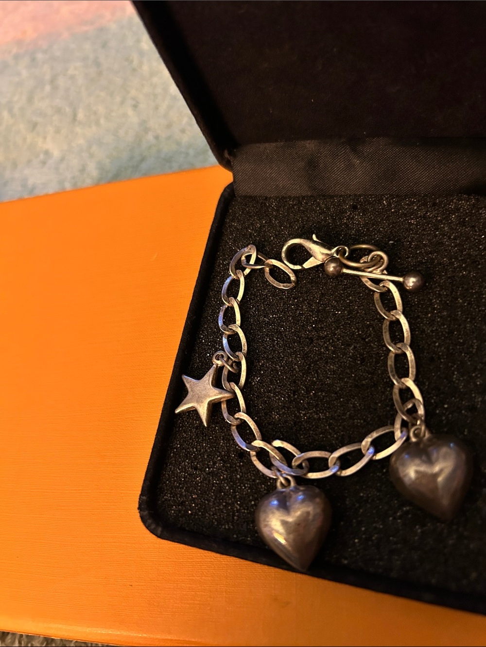 Sterling silver charm bracelet with 3 charms- 2 puffed hearts and 1 star. Simple